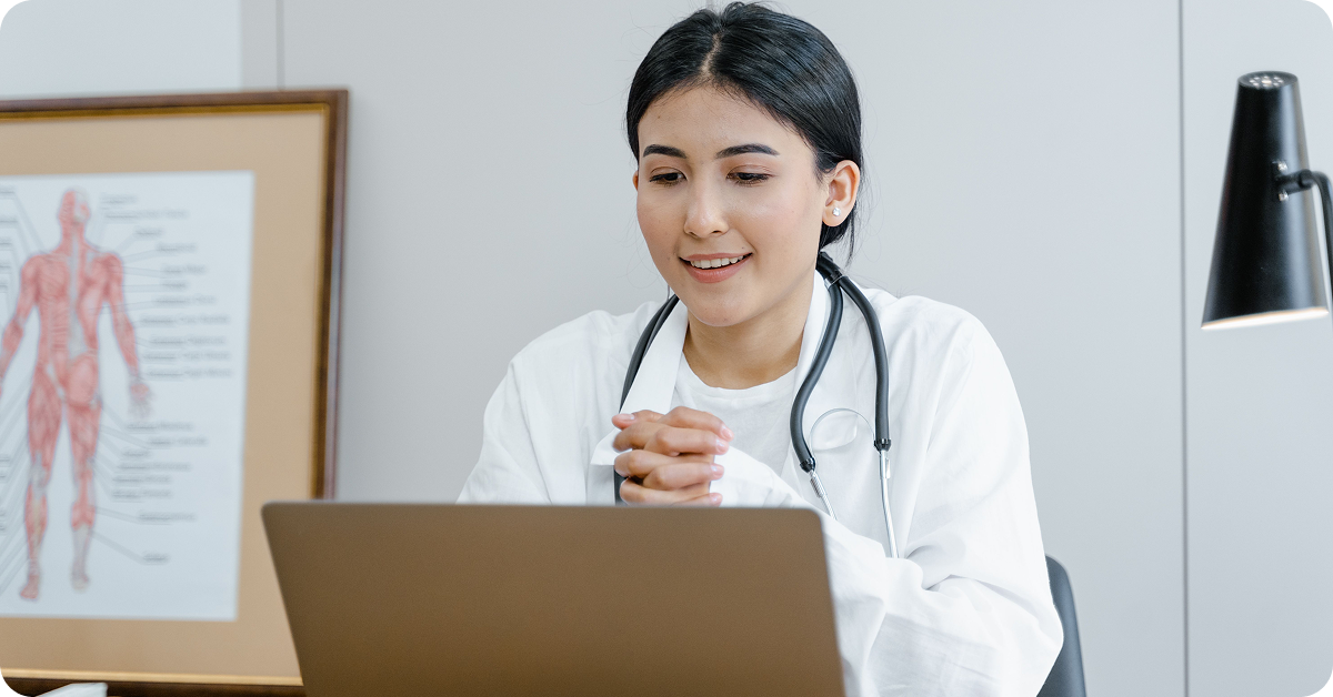 doctor-smiling-at-laptop